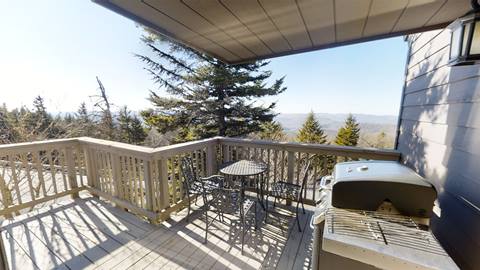 Private deck at Pedestal House vacation rental with a gas grill, outdoor dining set, and scenic mountain views at Snowshoe resort