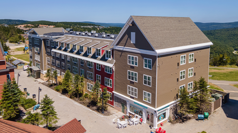 Exterior view of Expedition Station vacation rentals with a rental shop at Snowshoe Mountain Resort