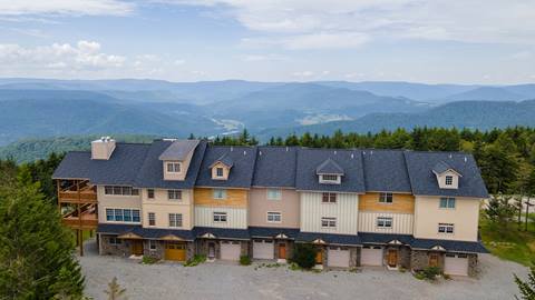 Shay’s Landing vacation rentals at Snowshoe Mountain, featuring multi-level townhomes with garages and sweeping valley views
