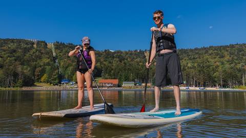 Two people on paddle boards on lake