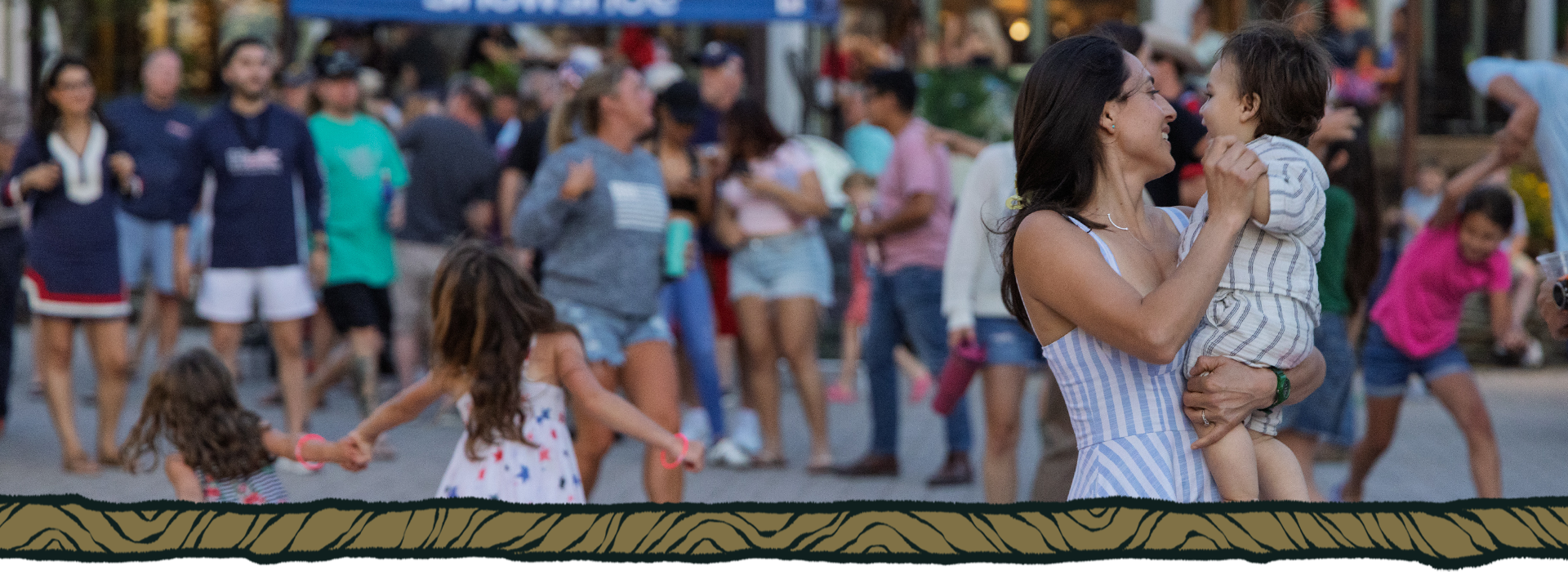 A family dances in front of a crowd at Snowshoe Mountain