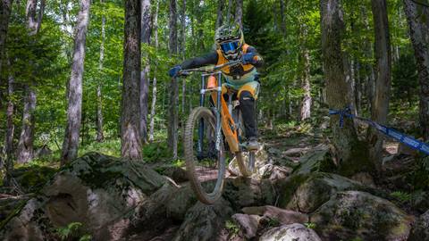 mountain biker going through a rock garden