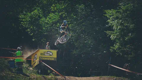 Biker hits a feature in the Bike Park at Snowshoe Mountain