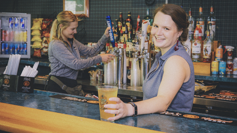 Bartender serves a drink at The Raven Grille at Snowshoe Mountain