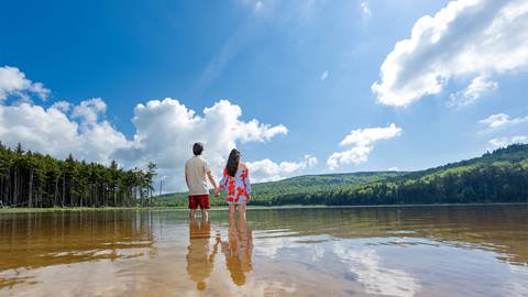Two people standing in Shavers Lake at Snowshoe Mountain