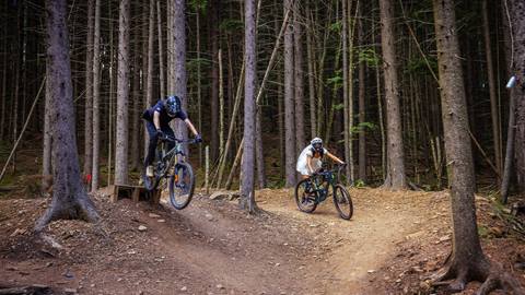 Bride and groom mountain biking at Snowshoe Mountain