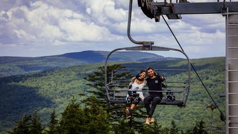 Bride and groom on a chairlift at Snowshoe Mountain Bike Park