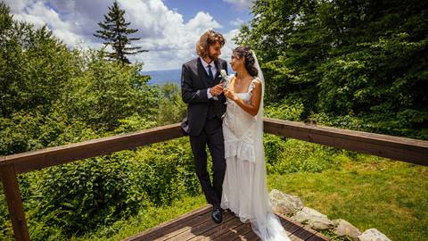 Bride and Groom clink champagne glasses at the Backcountry Hut | Snowshoe Mountain