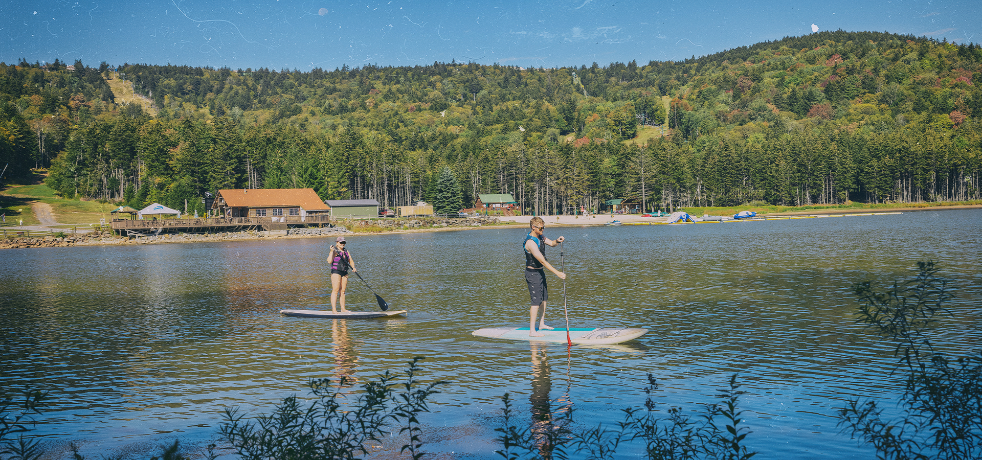 Paddleboarders on the lake at Snowshoe Mountain