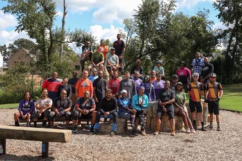 A group of people posing for a photo after a day of mountain biking