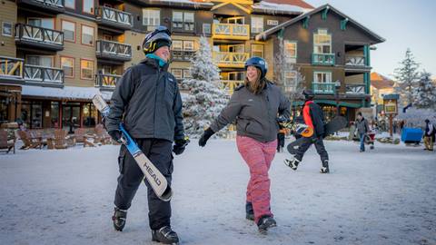 couple walking through Snowshoe Village
