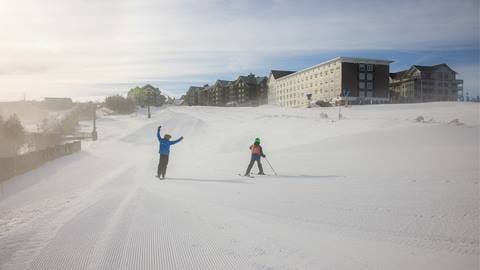 ski instructor and student on skidder