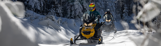 Snowmobiles cruising through fresh snow | Snowshoe Mountain