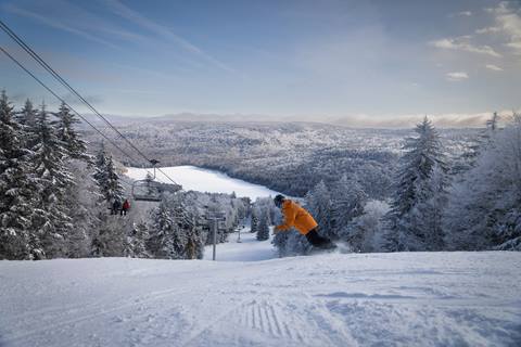 Snowboarder going down the slopes