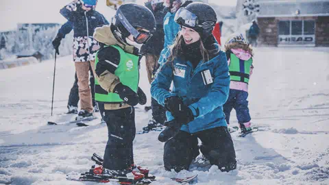 Ski school student and teacher at Snowshoe Mountain