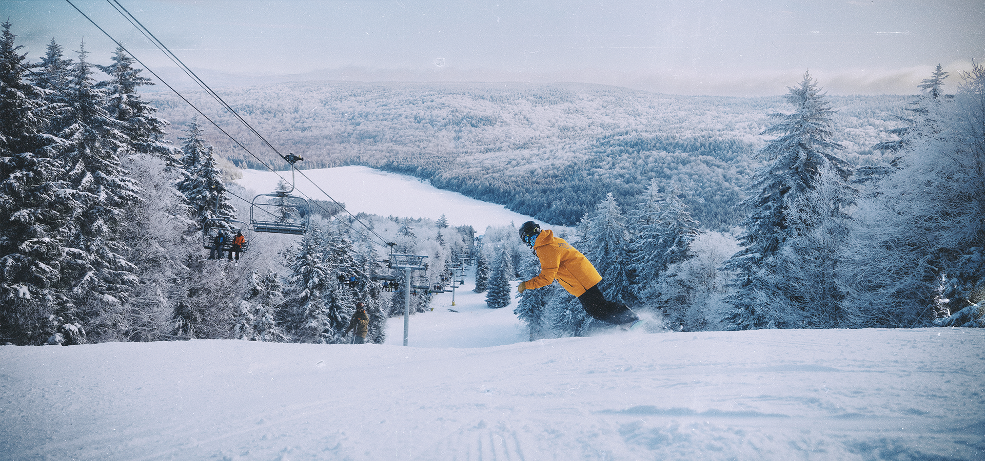 Snowboarder descends down the mountain on a winter day