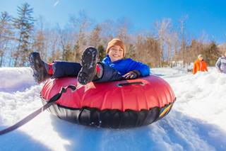 Child on tube at Coca-Cola Tubing Park